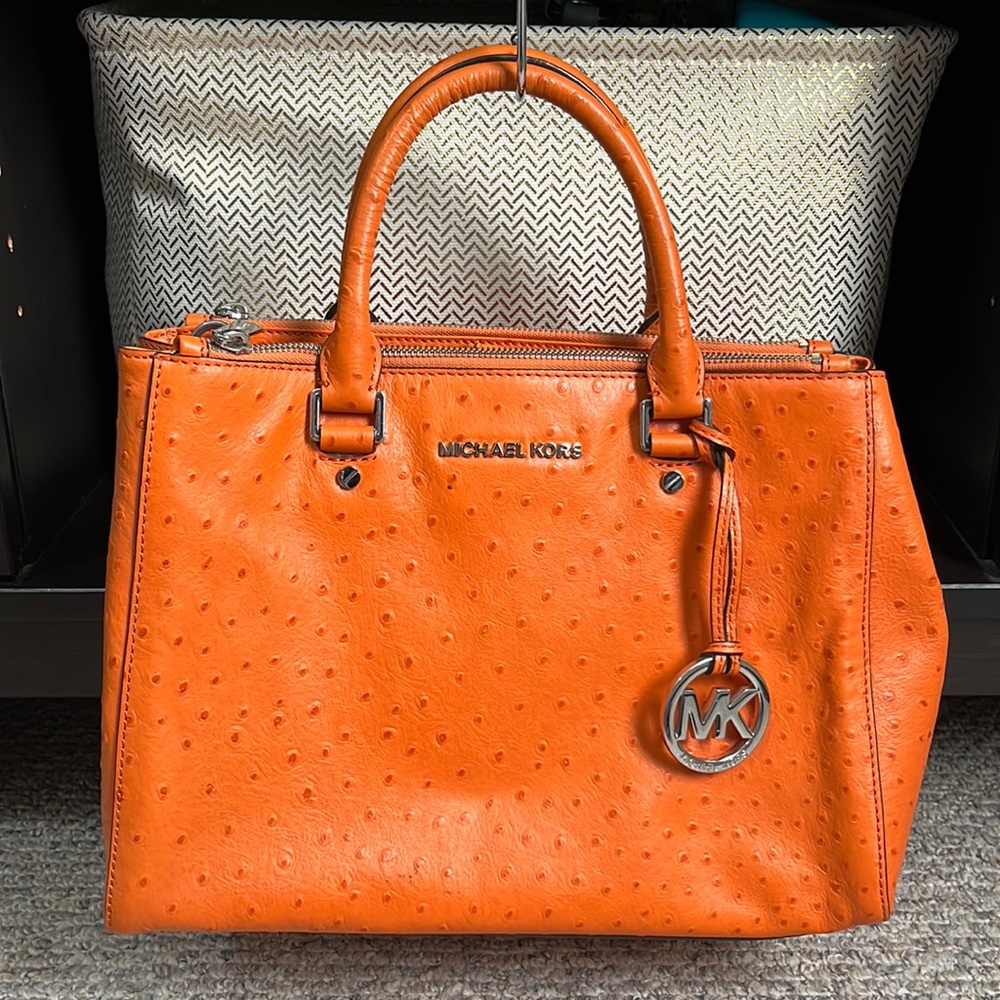 Michael Kors orange ostrich grain leather handbag.